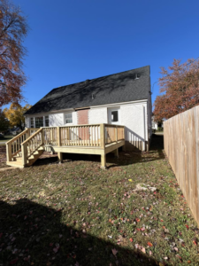 A completed backyard wooden deck project attached to a house by Brother George Remodeling & Construction in Louisville, KY.