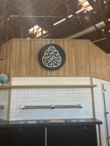 A completed bar area featuring installed beer taps and business logo by Black Tide Beverage in Lakewood, CO.