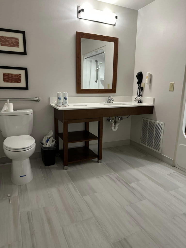 A newly completed bathroom renovation featuring a modern vanity, toilet, and tiled floor by Jay's Construction in Cincinnati, OH.