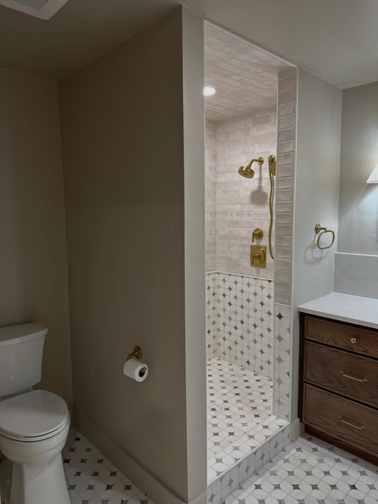 A completed bathroom renovation featuring a walk-in shower and new vanity by Le Roux Homes in Enid, OK.