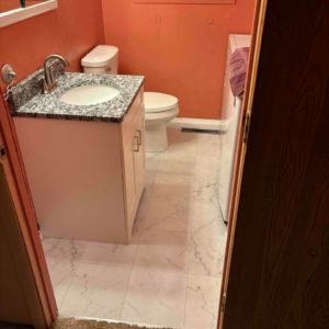 Completed bathroom renovation with new vanity, sink, faucet, and tiled floor by Mr. Handyman of Charleston and Summerville, Summerville, SC.