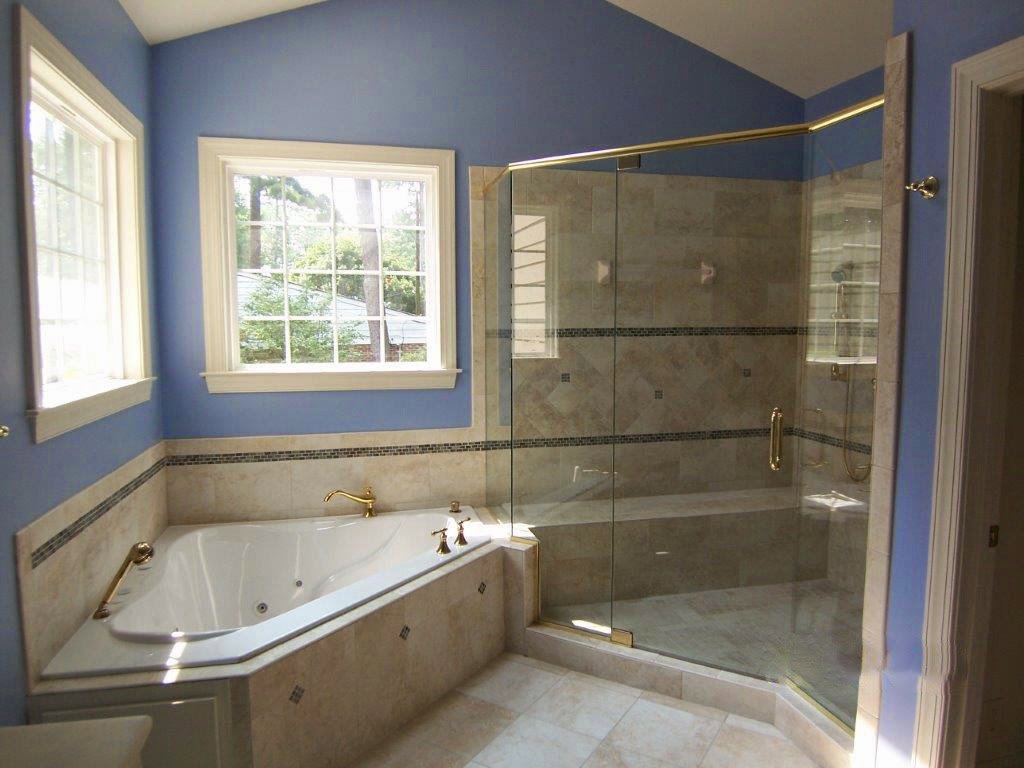 A completed bathroom renovation with a corner tub and glass shower enclosure by Rice Building Company in Rocky Mount, NC.