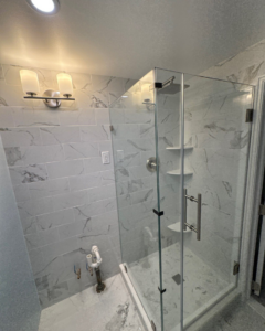 A completed modern bathroom shower with a glass enclosure and new fixtures by Clearview Home Remodeling in Parkville, MD.