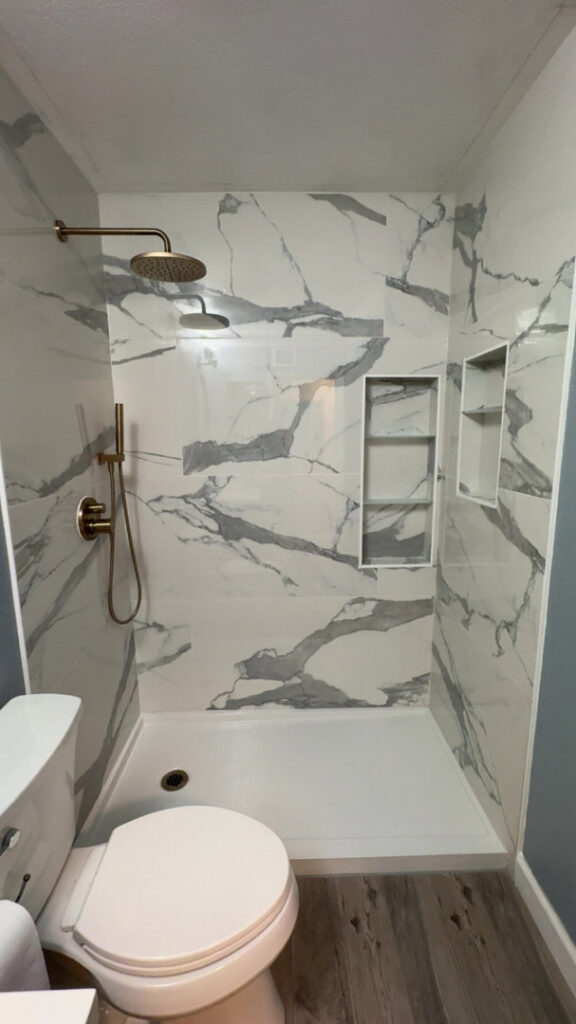 A completed bathroom shower and toilet area remodel with new tiles and flooring by Castillejo Handyman Services in San Diego, CA