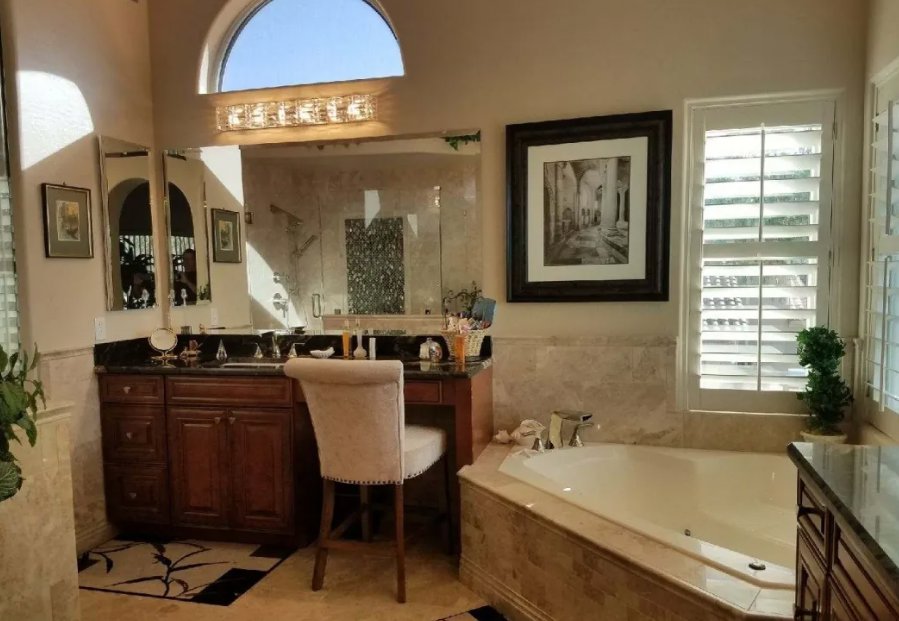 A completed bathroom remodel featuring a new vanity, tub, and shower by Southwest Restoration & Design, Inc. in Peoria, AZ.