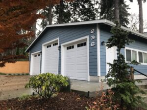 A newly completed garage with blue siding and white garage doors by Garages Etc in Tacoma, WA