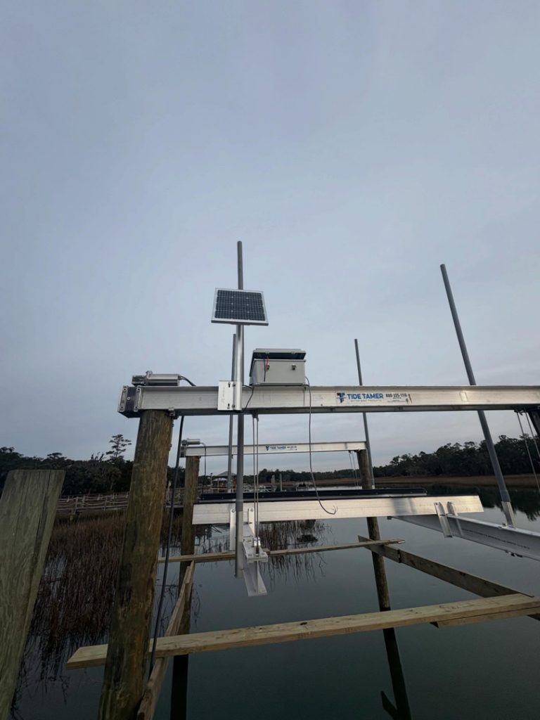 A newly installed boat lift with a solar panel, completed by Coastal Dock and Resurfacing in Beaufort, SC.