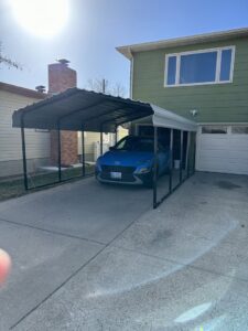 A newly installed carport with a car parked underneath, completed by B4 It Breaks in Billings, MT.
