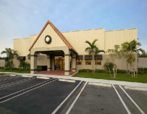 A newly completed commercial building with a parking lot, a project by Walker Design & Construction Co. in Boca Raton, FL.