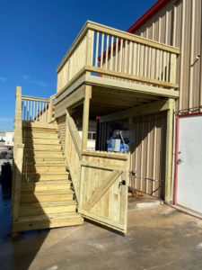 Completed commercial wooden deck and stairs with a gate built by JP Construction in San Antonio, TX.