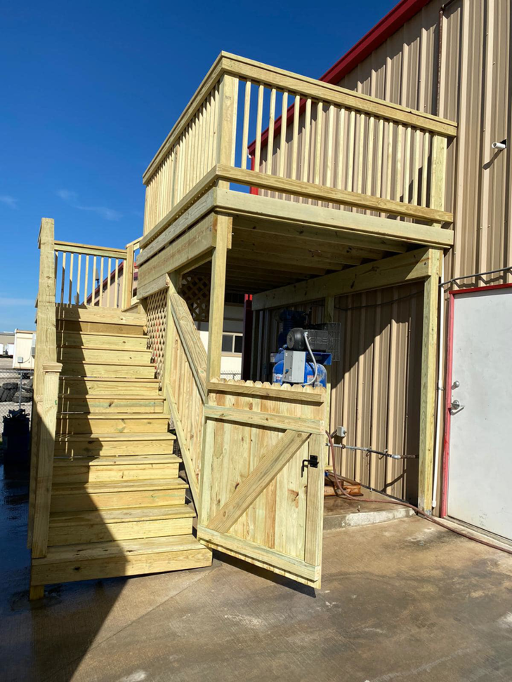 Completed commercial wooden deck and stairs with a gate built by JP Construction in San Antonio, TX.