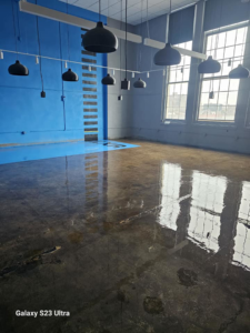 Completed commercial floor coating and wall painting in a large room by Logical Drywall and Painting in St. Louis, MO.