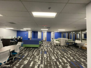 A newly renovated open-plan commercial office space with modern carpet and furniture by Ricos Renovations in Arlington, TX