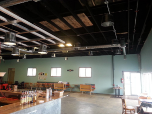 A newly renovated commercial space with a bar area and seating, completed by Work Horse Contracting in West Fargo, ND.