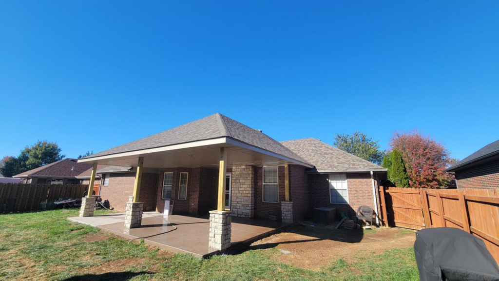 A beautifully completed covered patio addition with stone columns by Classic Home Concepts in Springfield, MO