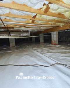 A completed crawlspace encapsulation project with a white vapor barrier and batt insulation by Palmetto Crawlspace in Mount Pleasant, SC.