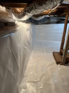 A clean and fully encapsulated crawlspace with a white vapor barrier installed by Appalachian Foundation Services in Roanoke, VA.