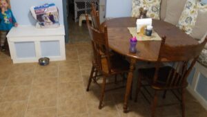 A completed custom built-in bench with storage in a dining area, showcasing handyman carpentry by MG'S Services LLC in Albuquerque, NM.