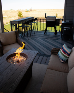 A beautifully completed deck featuring outdoor furniture and a cozy fire pit by TNC Builders, LLC in Aurora, CO