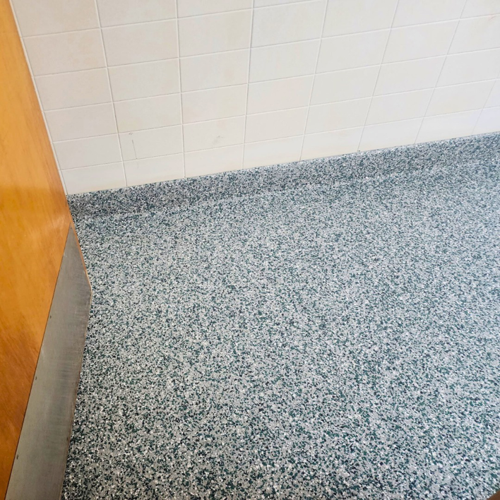 A newly installed speckled epoxy floor in a bathroom by Lifetime Epoxy Floors North Alabama in Boaz, AL.