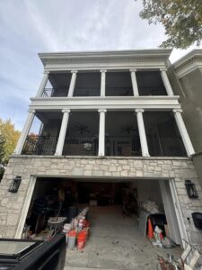 A completed exterior house project with balconies and a garage by Tribute Painting & Drywall in St. Louis, MO.