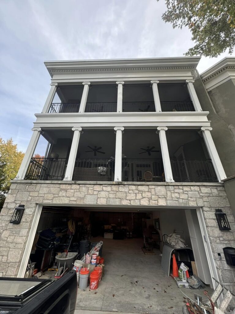 A completed exterior house project with balconies and a garage by Tribute Painting & Drywall in St. Louis, MO.
