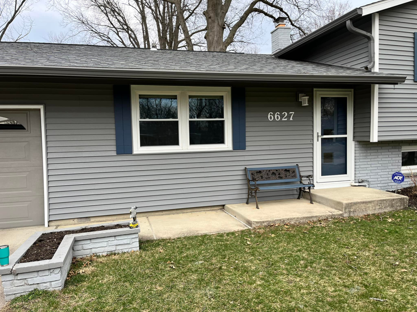 A completed exterior house renovation featuring new siding and windows by Lambert's Residential Painting And More LLC in Fort Wayne, IN.