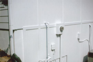 A freshly painted white exterior wall with neatly installed pipes and electrical boxes by AAA Lifetime Exterior & Remodeling LLC in Kansas City, MO.