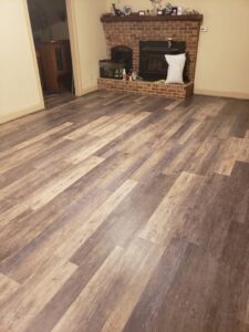 Completed new flooring installation in a living room by Priority Property Services in Salisbury, MD.