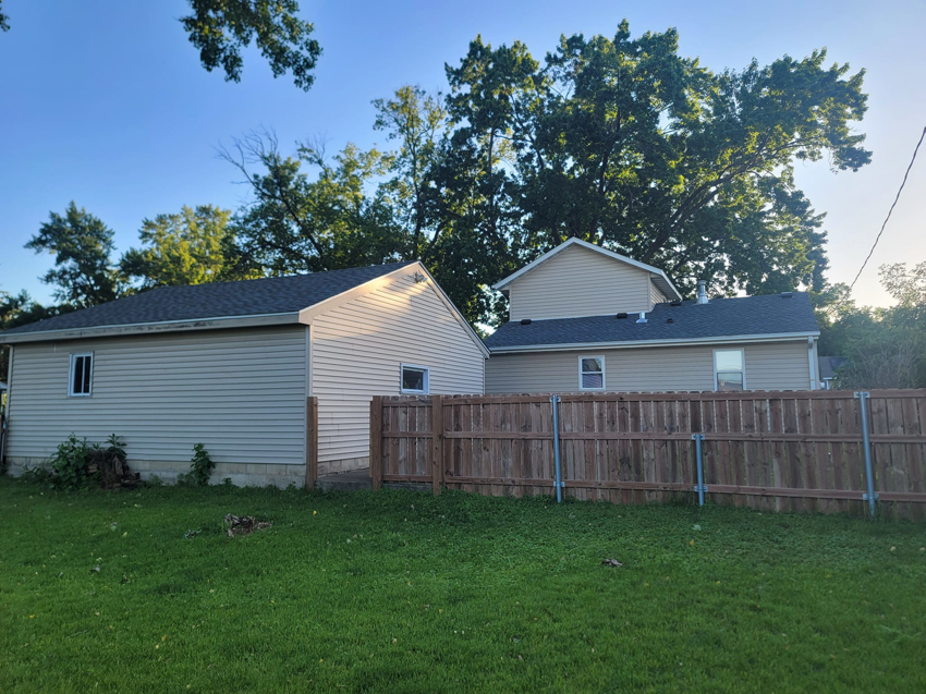 Completed exterior renovation of a garage and house with new siding and roof by INT-X Remodeling LLC in Woodbury, MN.