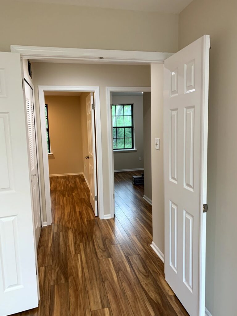 A completed interior hallway renovation with new laminate flooring and freshly painted walls by S-G General Contracting LLC in Philadelphia, PA.