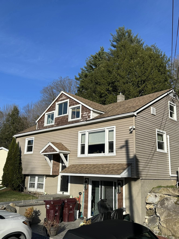 A fully renovated house exterior with new roof and siding, completed by Next Generation Carpentry LLC in Bennington, VT.