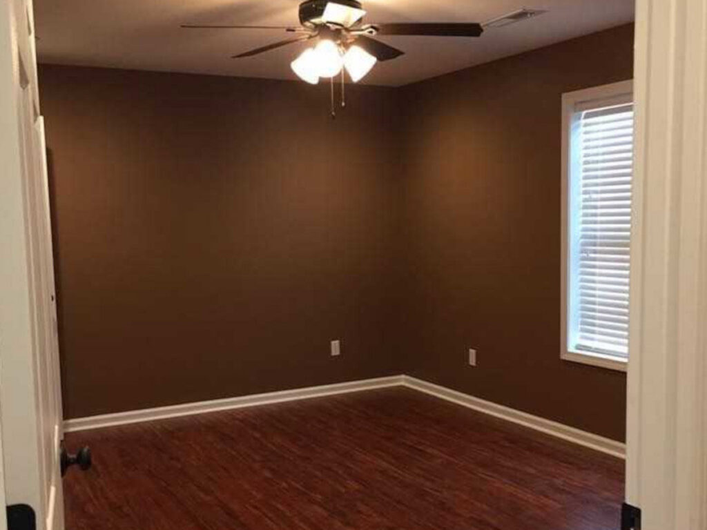 A completed interior room renovation featuring new paint and flooring, a service by Huntington Home Repair in Huntington, WV.