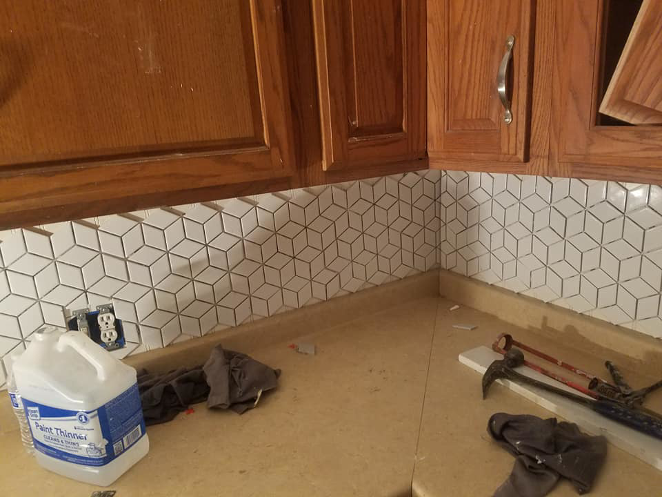 A completed geometric kitchen backsplash tile installation in a corner, a service by Clayton's Remodeling And Home Services in Vero Beach, FL.