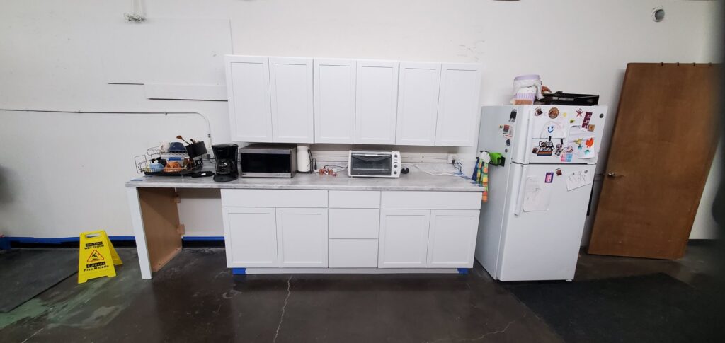 Newly installed white kitchen cabinets and countertop by Justin-case Repairs in Ankeny, IA.