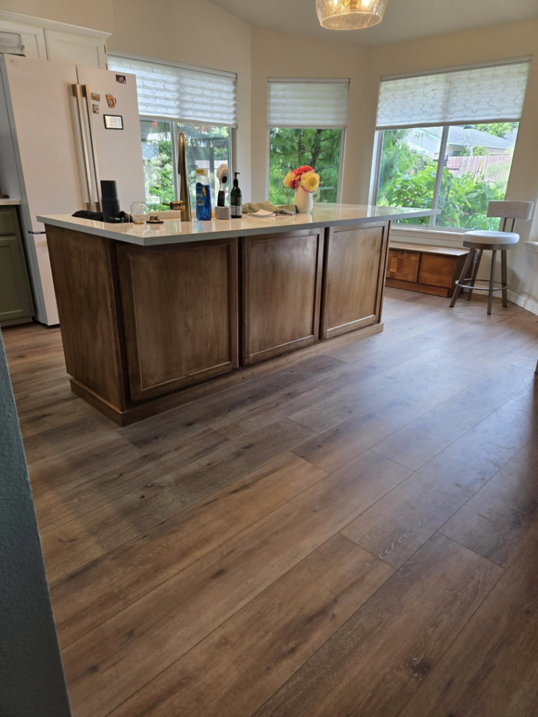 A beautifully completed kitchen with new flooring and a central island by Stephen Appel Handyman/Contractor in Meridian, ID.