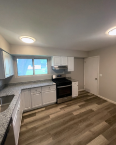 A beautifully completed kitchen remodel with new cabinets, countertops, and flooring by Make It Happen Homes STL in St. Louis, MO.