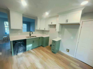 A completed kitchen remodel featuring white and green cabinets by Wise Construction Group in Atlanta, GA.