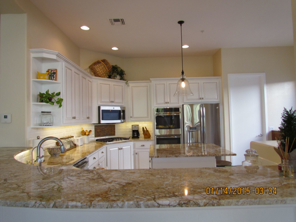 A completed kitchen remodel featuring white cabinets and granite countertops by Celano Construction in Mesa, AZ