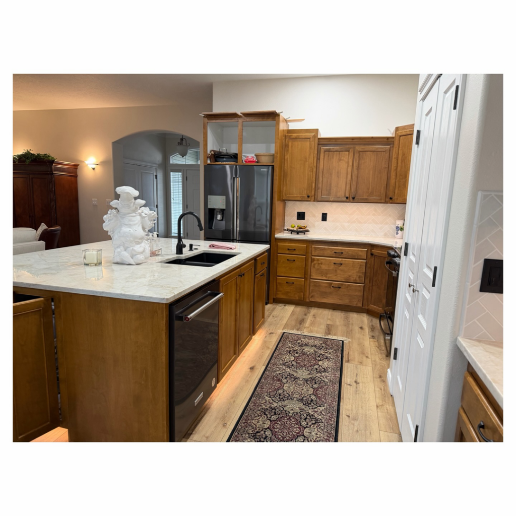 A beautifully completed kitchen remodel featuring a large island and new appliances by Tom Broglia Building & Remodeling Services in Boise, ID.