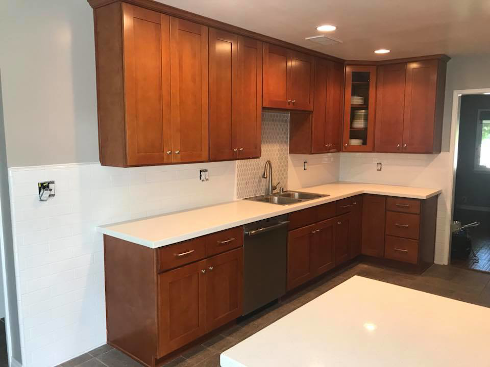 A completed kitchen renovation featuring brown cabinets and new backsplash by Johnson Handyman Services in Anderson, SC.