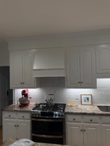 A beautifully completed kitchen renovation featuring white cabinets and granite countertops by Rice Building Company in Rocky Mount, NC.