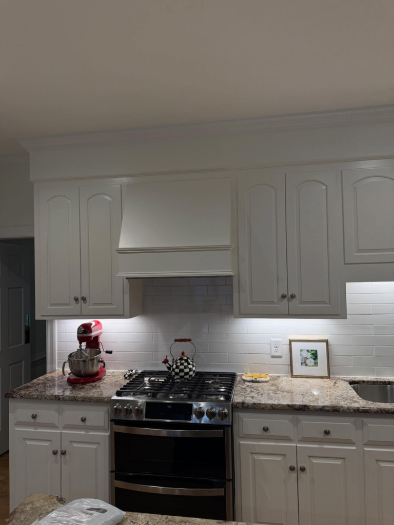 A beautifully completed kitchen renovation featuring white cabinets and granite countertops by Rice Building Company in Rocky Mount, NC.
