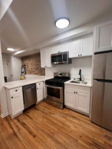 A beautifully completed modern kitchen remodel with white cabinets and stainless steel appliances by Rosado Brothers in Chicago, IL