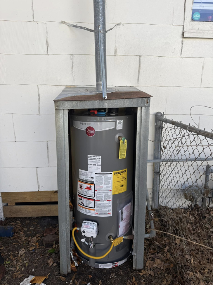 A completed outdoor water heater installation with a vent pipe by High Tide Home Remodeling in Charleston, SC.