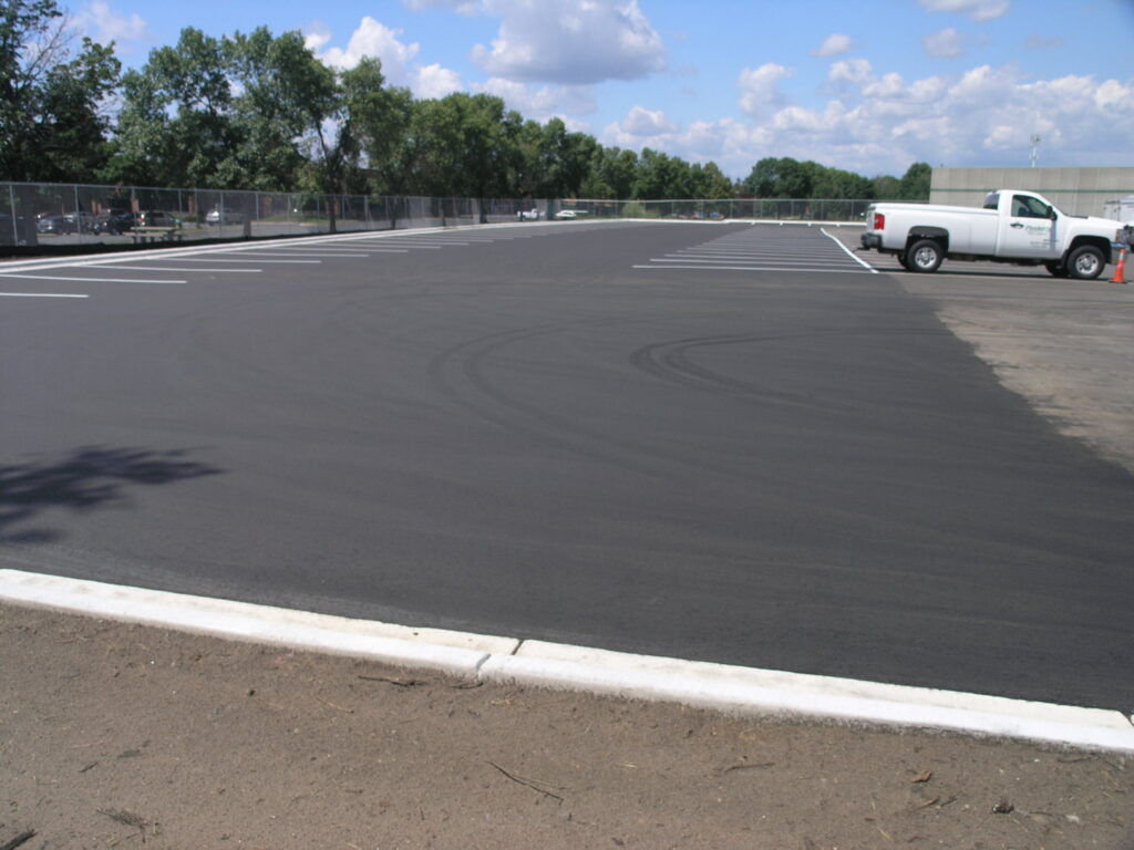 A completed parking lot paving project with new line markings by Buck Blacktop Inc in Little Canada, MN.