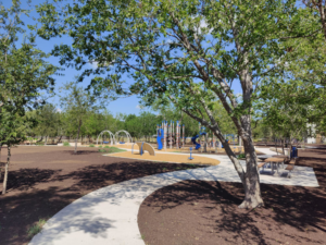 Completed playground with equipment, paths, and mulched ground by Paradigm Contracting LLC in Wichita, KS.