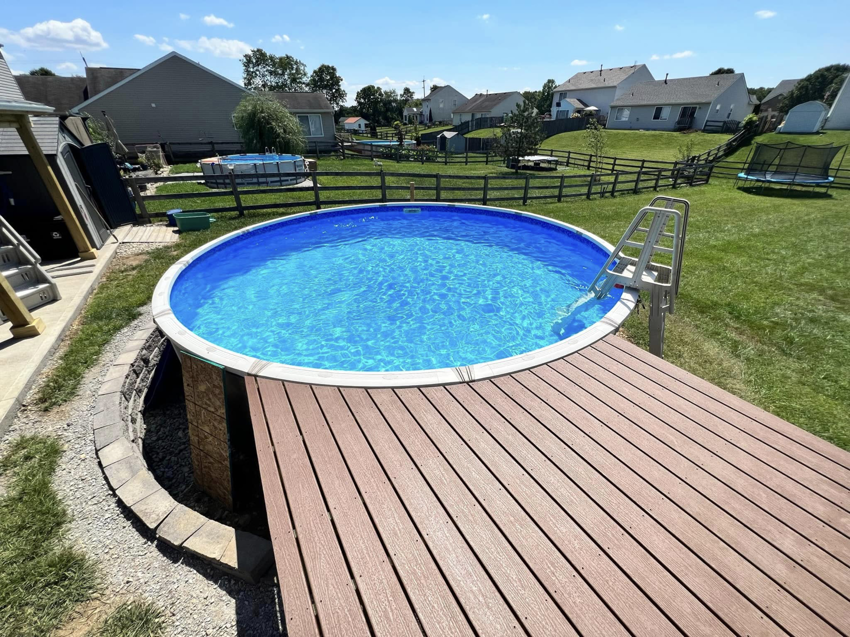 A newly completed wooden deck surrounding an above-ground pool by Armbruster General Contracting in Cincinnati, OH.