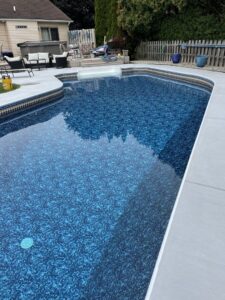 A completed pool liner replacement project, showing a clean, blue pool by Heatwave Pools LLC in Flint, MI.