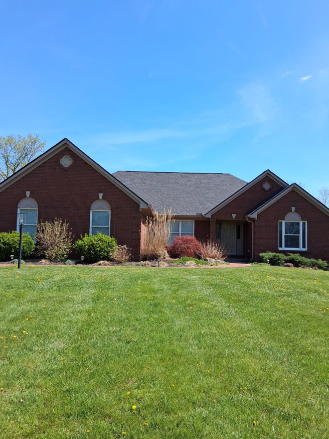 A beautiful residential home with a newly completed roof replacement by Elegant Home Exteriors in Flourance, KY.